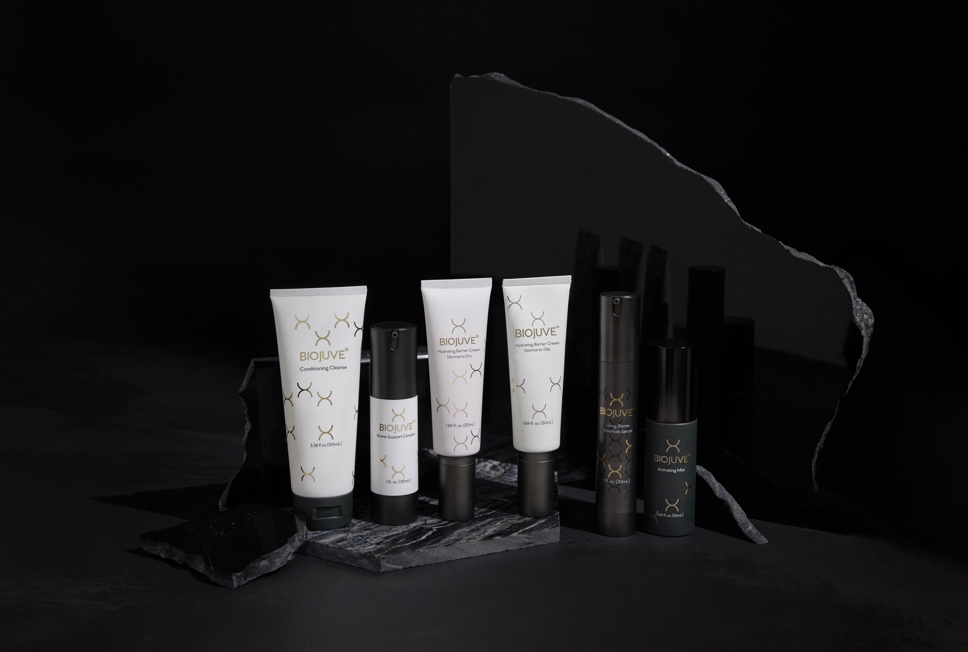 The full BIOJUVE product lineup on dark slate.